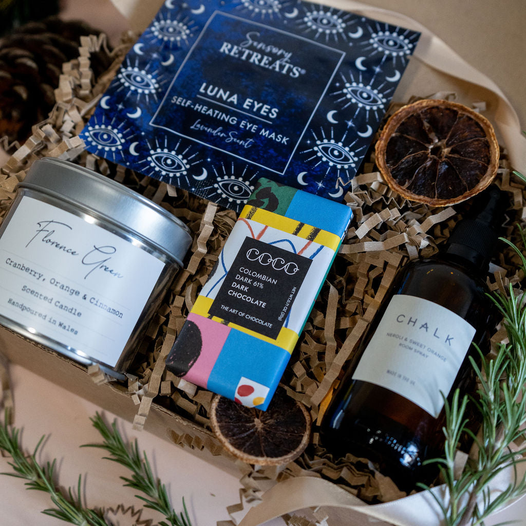 Relax and recharge gift box with self heating eye mask, mini dark chocolate bar, orange and neroli room spray, and choice of sox wax tin candle from Florence green, sent in our joyful mailer box with a handwritten note.