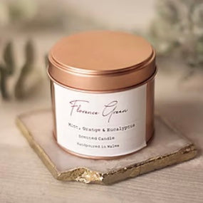 Silver tin candle from Florence green scent of mint, orange and eucalyptus on a beige background