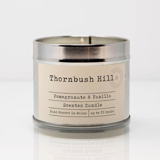 Thornbush Hill Silver Tin Soy Wax candle of pomegranate and vanilla on a white background, vegan and handpoured in Wales