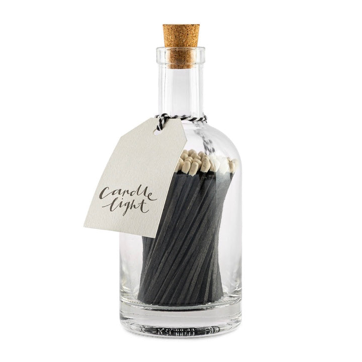 Apothecary glass bottle of long luxury matches from Archivist - matches are black with white tips and tag with candle light