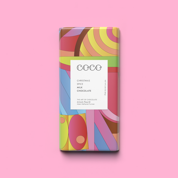 Image of Christmas spice milk chocolate bar from Coco Chocolatier on pink background
