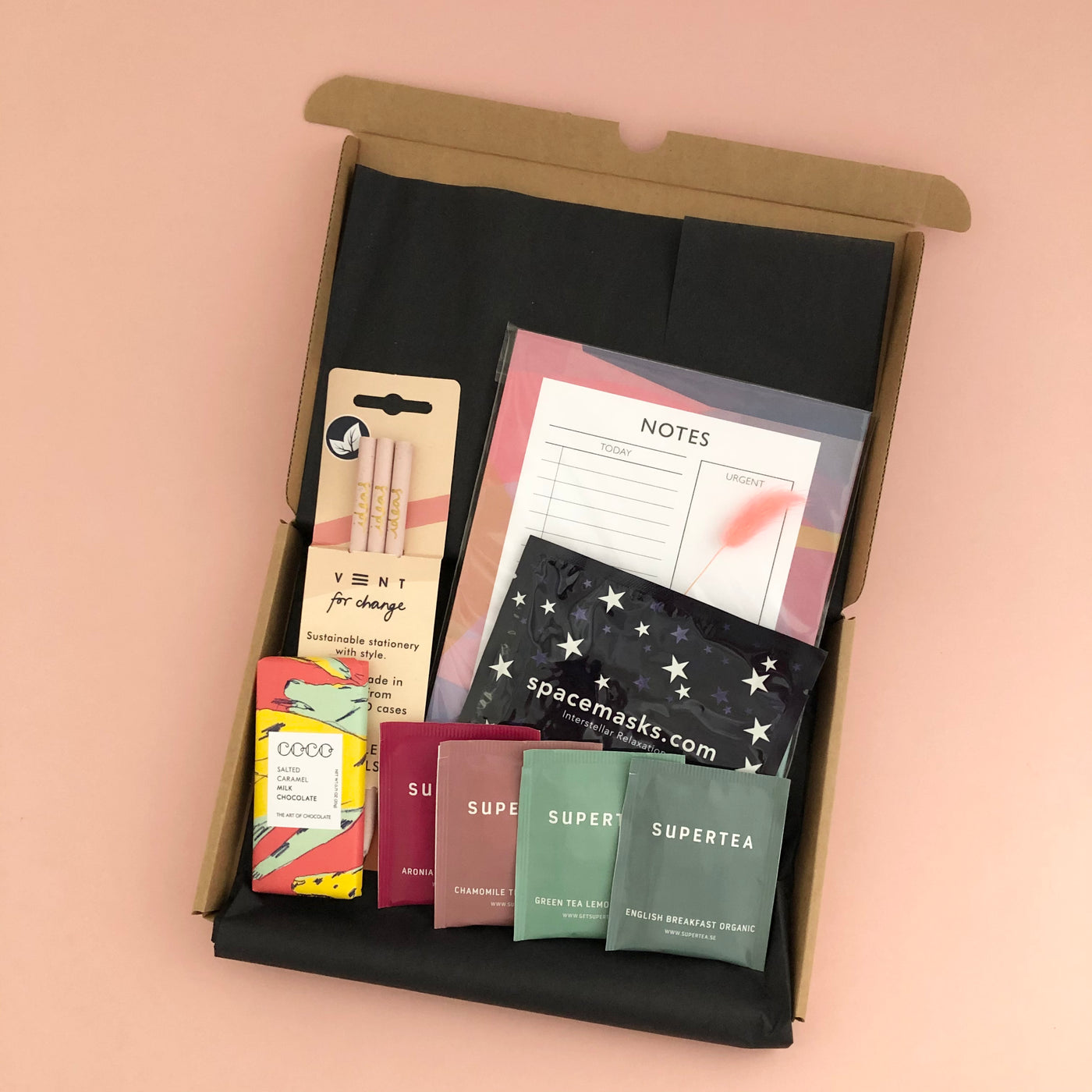 Letterbox friendly get organised gift box contians A5 to do list from Mock up designs, Self heating eye mask from Spacemasks, Artisan salted caramel mini bar from coco chocolatier, 4 sachets of organic tea from supertea, and pack of 3 light pink recycled pencils from vent 4 change